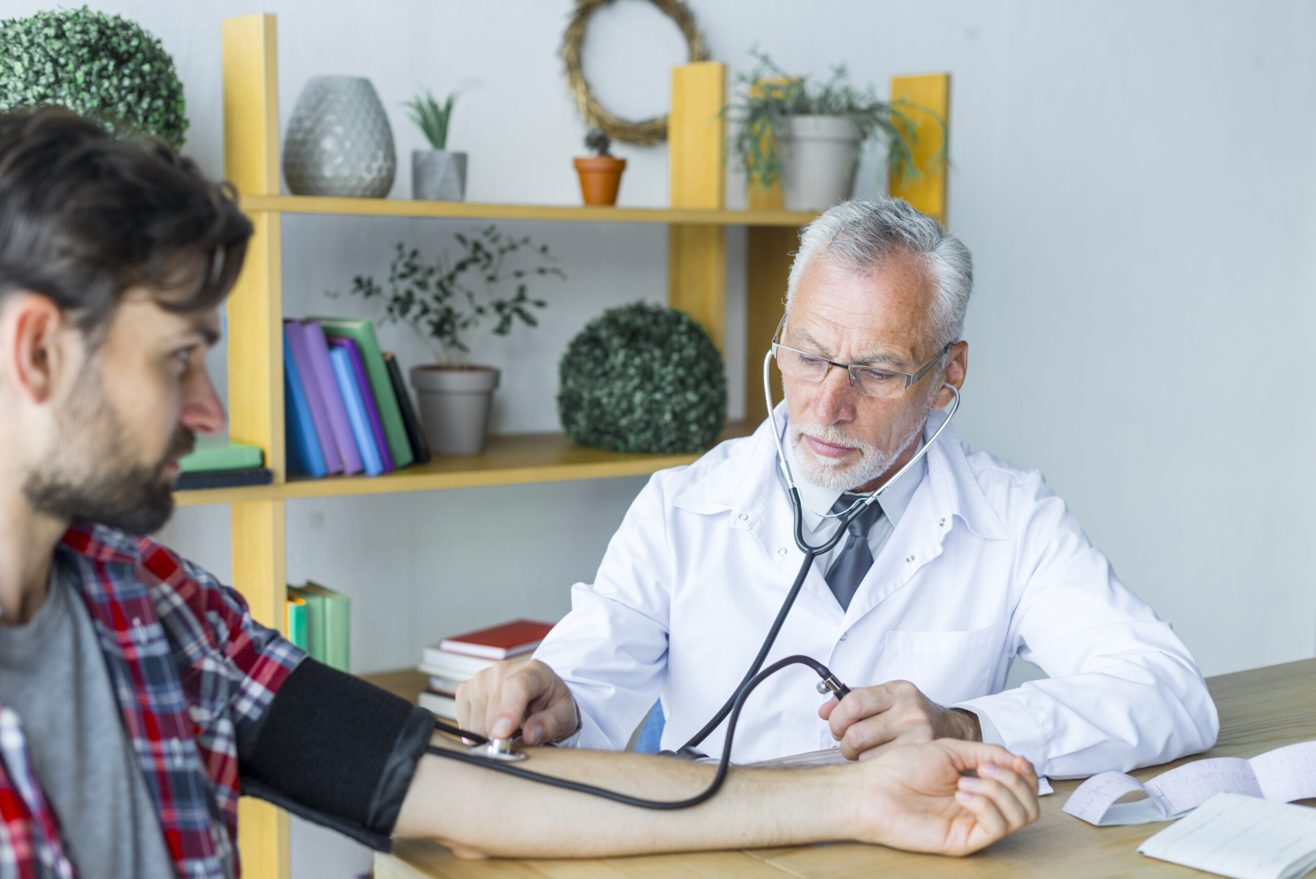 Image doctor measuring blood pressure young patient scaled 1